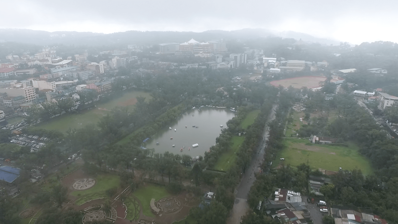 Baguio City Philippines from above drone shot with a cloudy rainy horizon.